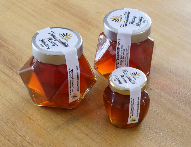 3 jars of honey on a table